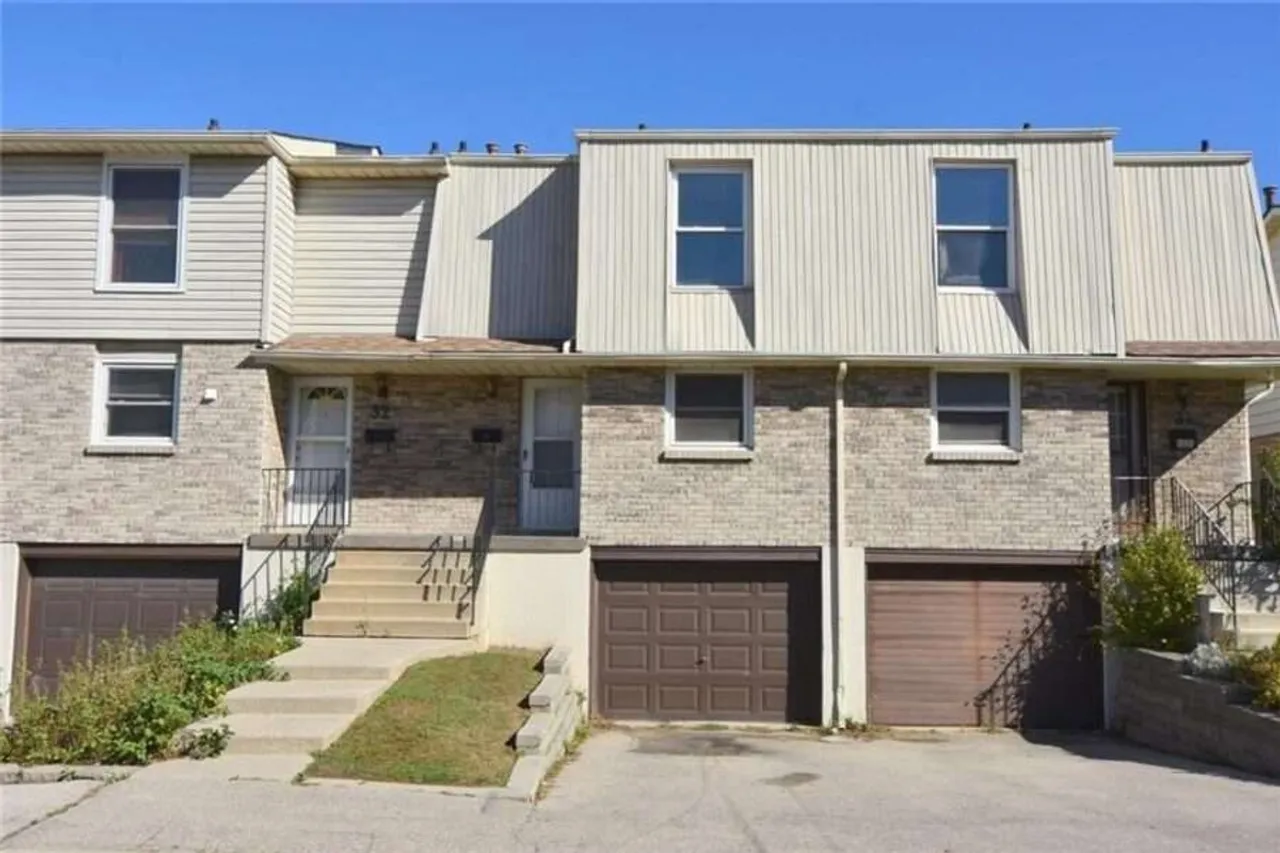 Front exterior of a brick and siding townhouse complex on Angus Road