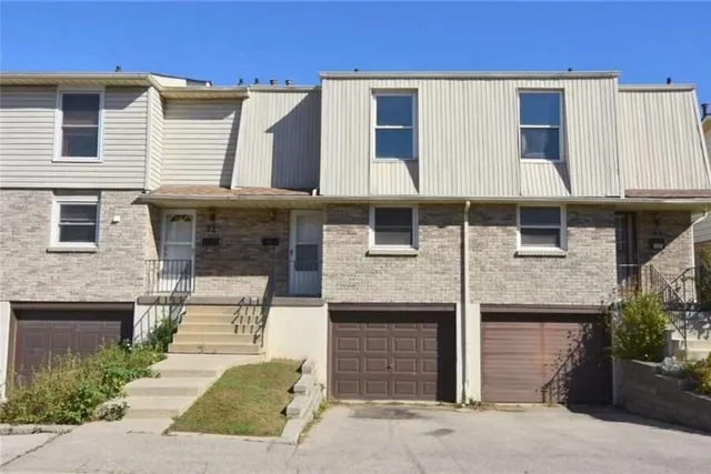 Front exterior of a brick and siding townhouse complex on Angus Road