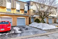 Front exterior of a brick townhouse with single garage on Glen Vista Drive