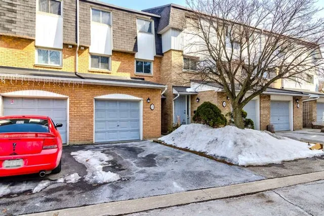 Front exterior of a brick townhouse with single garage on Glen Vista Drive