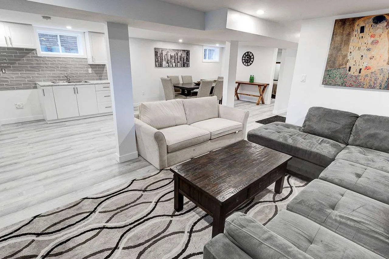 Finished basement living room with a sectional sofa and fireplace TV stand