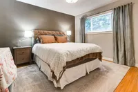 Bedroom with a dark accent wall and bedside lamps