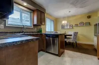 Main floor eat-in kitchen with dark wood cabinetry and a dining nook