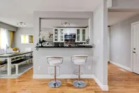 Kitchen pass-through bar with white cabinetry overlooking the dining area
