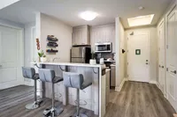 Kitchen viewed from the unit entrance, with stacked storage