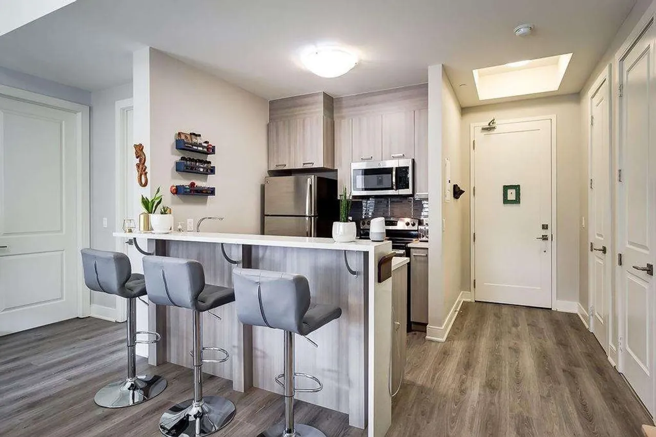 Kitchen viewed from the unit entrance, with stacked storage