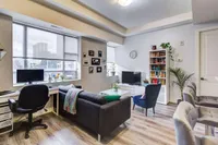 Living room with a desk and office nook by the window