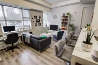 Living room with city views and a bookshelf