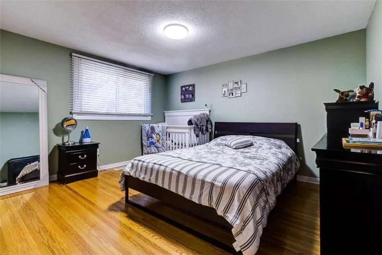 Bedroom with green walls and a large mirror