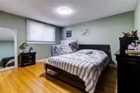 Bedroom with green walls and a large mirror
