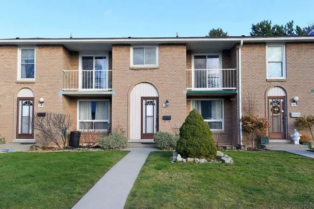 Front exterior of unit 103 in a brick townhouse complex on Gateshead Crescent