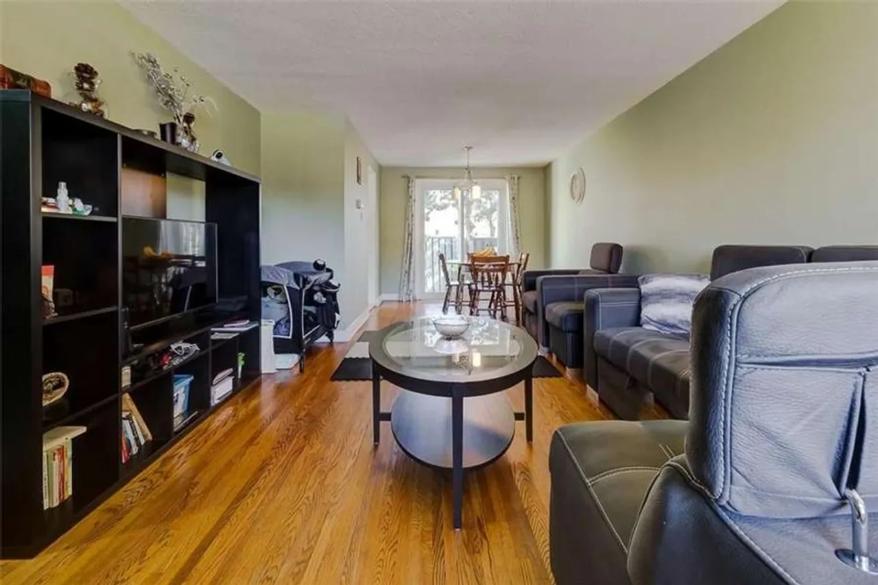 Living room and dining area with a walkout to a balcony