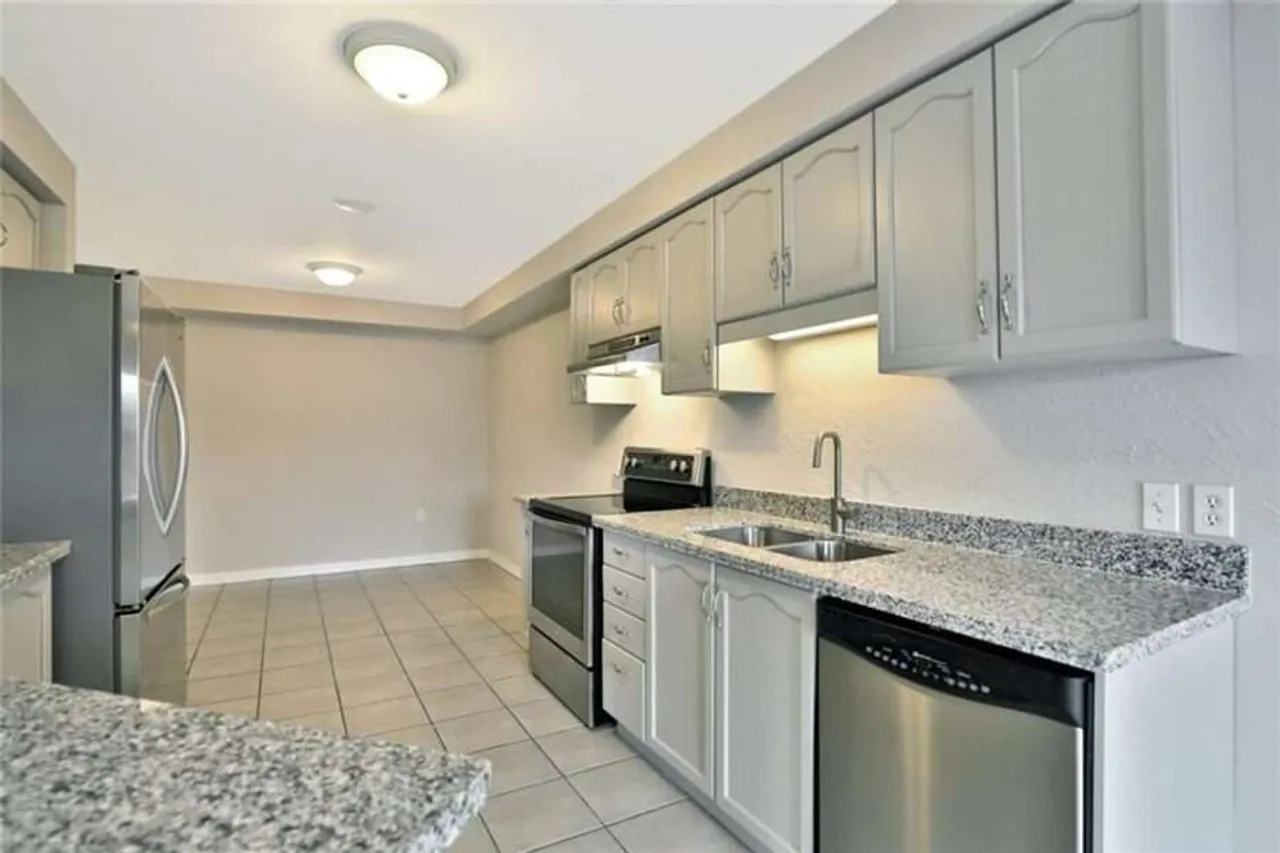 Galley kitchen with stainless steel appliances