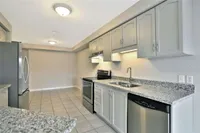 Galley kitchen with stainless steel appliances