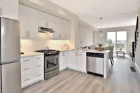 Kitchen with stainless steel appliances and a sliding patio door