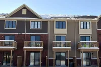 Rear exterior with private balconies on a snowy day