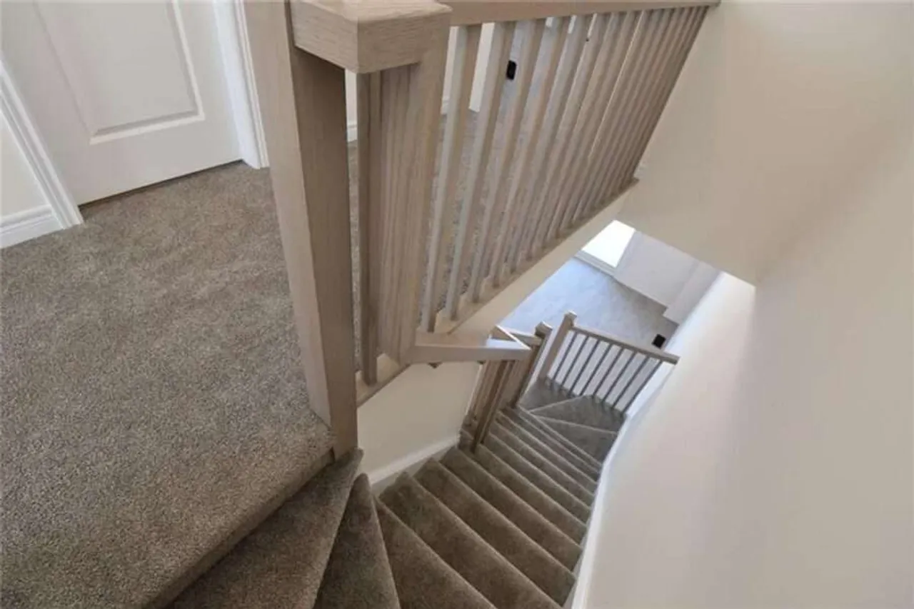 Carpeted staircase between levels