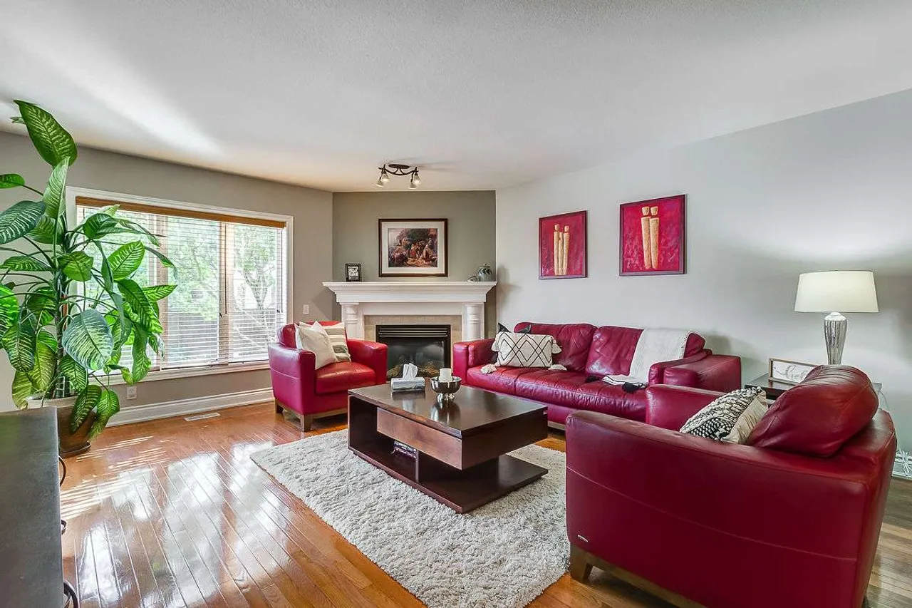 Family room with red leather sofas and a gas fireplace