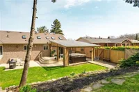 Backyard deck with a covered hot tub area