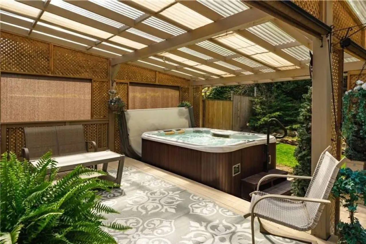 Covered hot tub nestled against the escarpment treeline