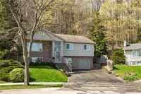 Front exterior of a raised ranch bungalow on Brae Crest Drive backing onto treed escarpment land
