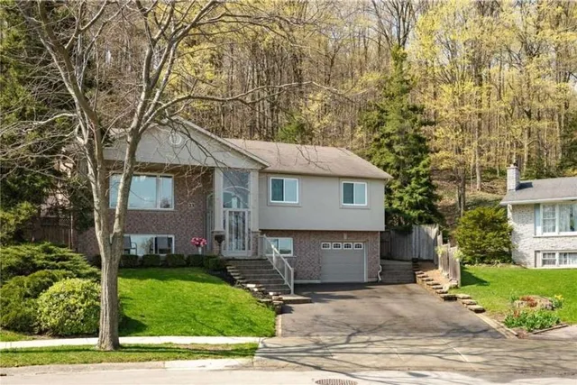 Front exterior of a raised ranch bungalow on Brae Crest Drive backing onto treed escarpment land