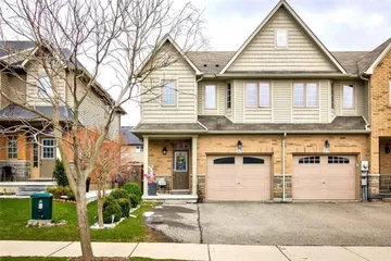 Front exterior of an end-unit freehold townhouse with double garage on Bankfield Crescent