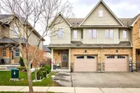 Front exterior of an end-unit freehold townhouse with double garage on Bankfield Crescent
