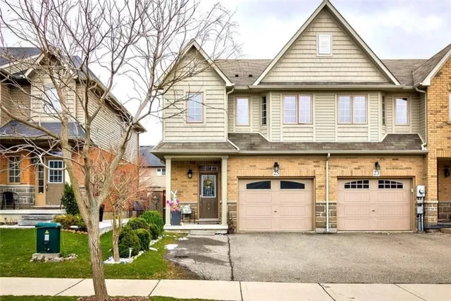Front exterior of an end-unit freehold townhouse with double garage on Bankfield Crescent
