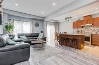 Open-concept maple kitchen with island, overlooking the living room