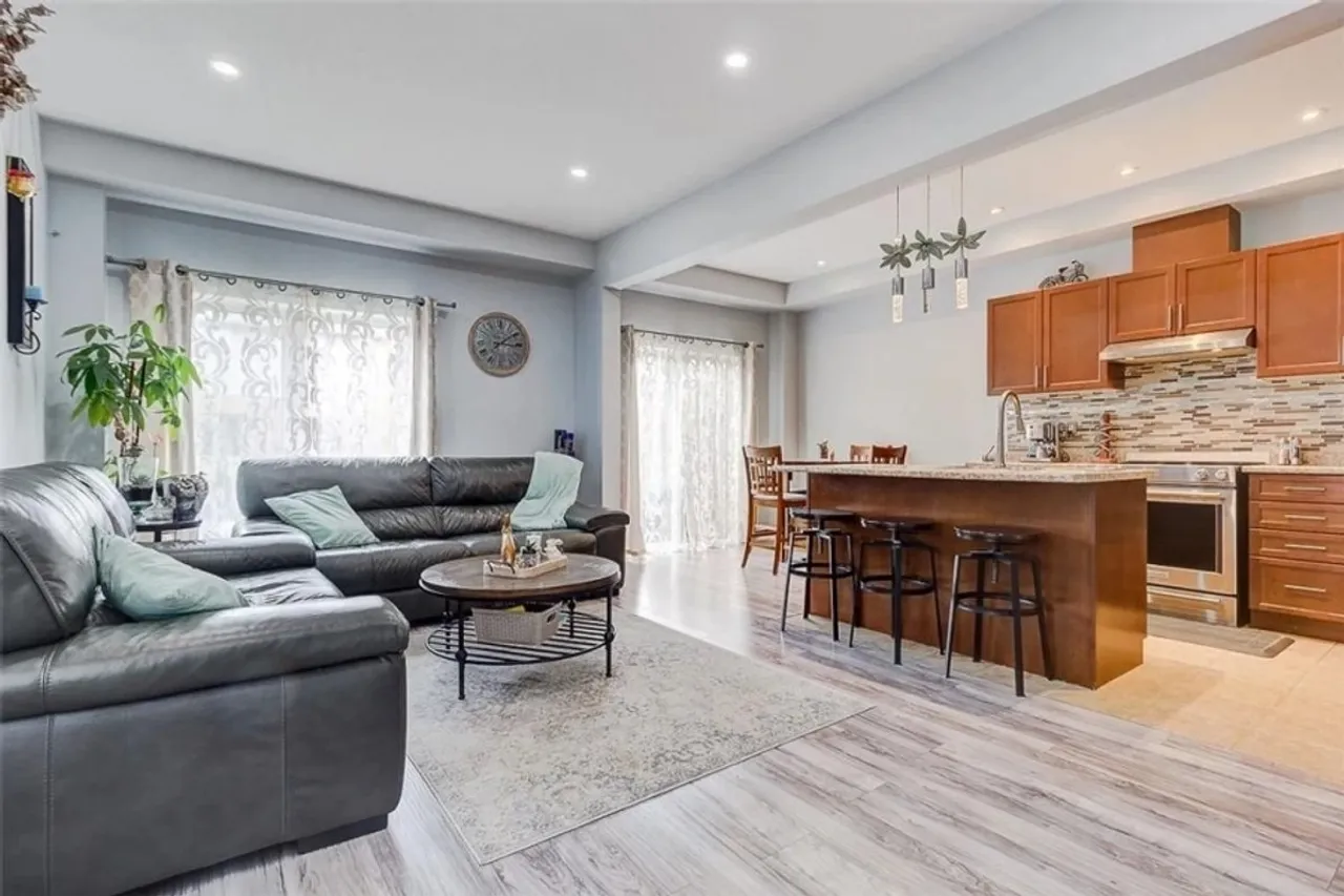 Open-concept maple kitchen with island, overlooking the living room