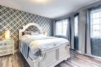 Primary bedroom with a patterned accent wall