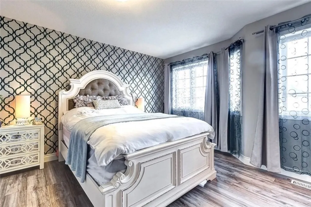 Primary bedroom with a patterned accent wall