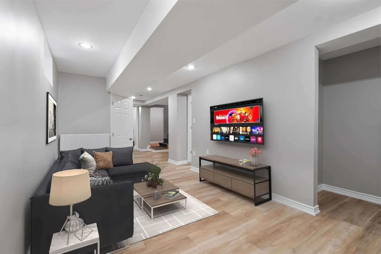 Finished basement recreation room with a stone fireplace