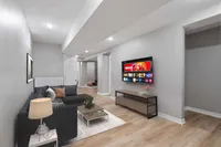 Finished basement recreation room with a stone fireplace