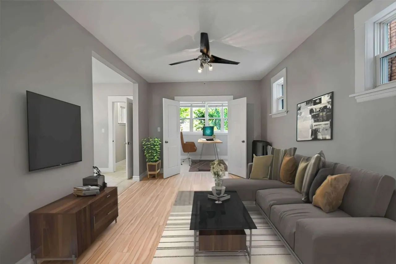 Living room with leather sectional sofas and a French-door office nook
