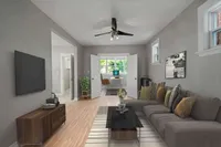 Living room with leather sectional sofas and a French-door office nook
