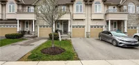 Front exterior of a two-storey brick-and-stucco townhome at 34 Forest Valley Crescent with an attached garage and interlock driveway