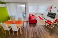 Living and dining room with a walkout to a private balcony