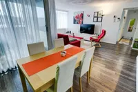 Living and dining room viewed from the entry, with city view through the balcony door