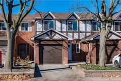 Front exterior of a Tudor-style brick townhouse on Longmoor Drive in the Strathcona Gardens community of Burlington
