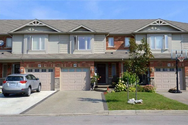 Front exterior of a brick townhouse row on Escarpment Drive in Winona