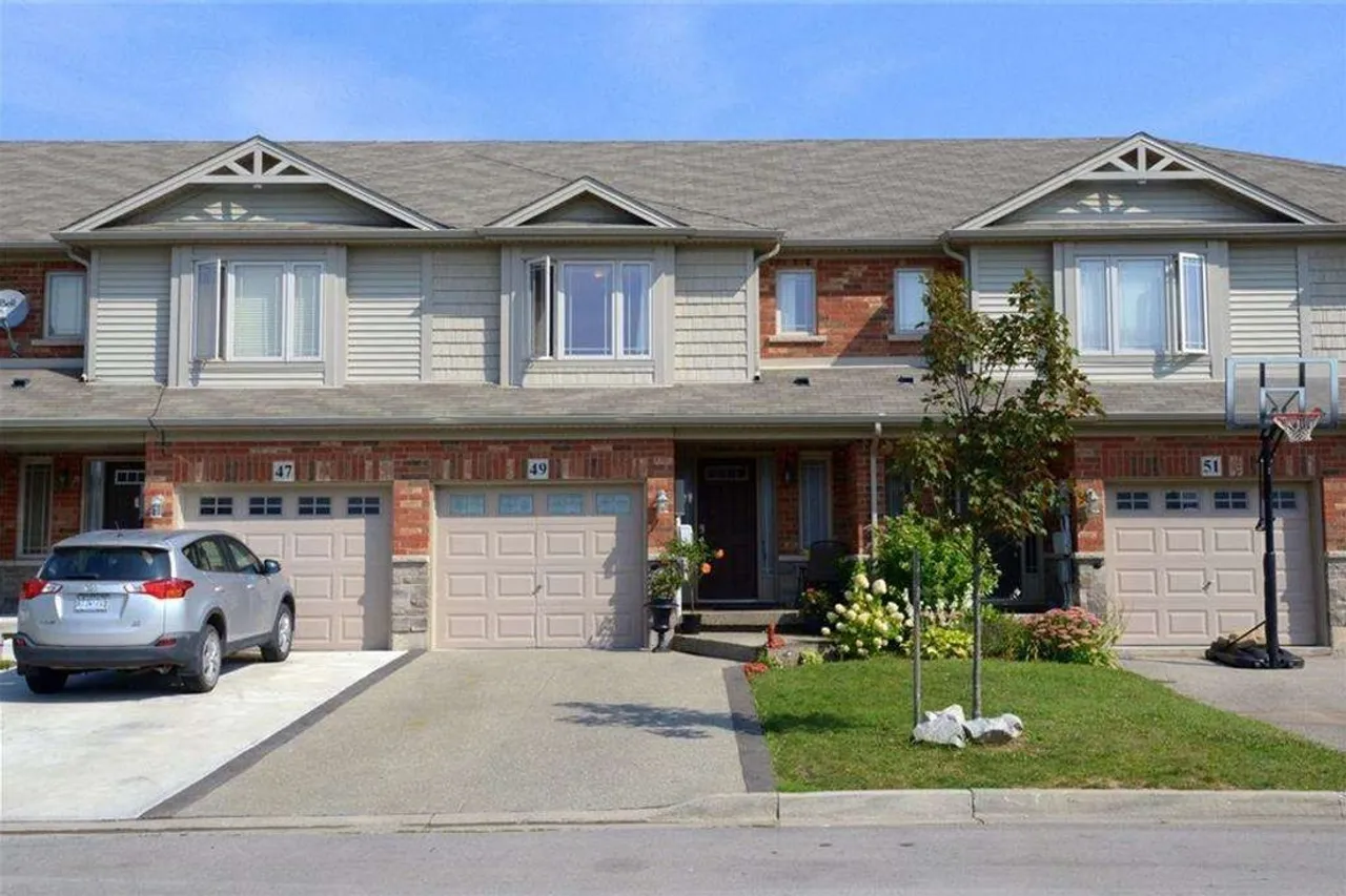 Front exterior of a brick townhouse row on Escarpment Drive in Winona