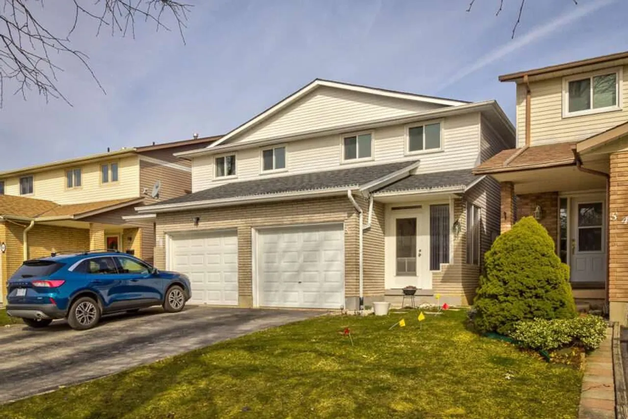 Front exterior of a two-storey brick home with double garage on Athenia Drive