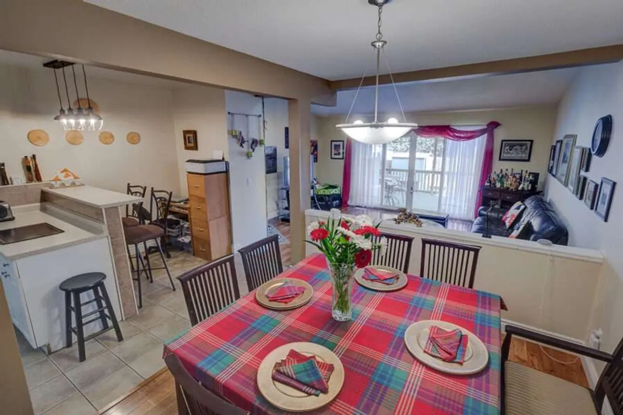 Open-concept kitchen and dining area with a deck walkout