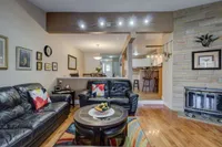 Living room with leather sectional sofa and a stone fireplace