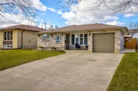 Front exterior of a stone and brick bungalow-style backsplit on Highridge Avenue