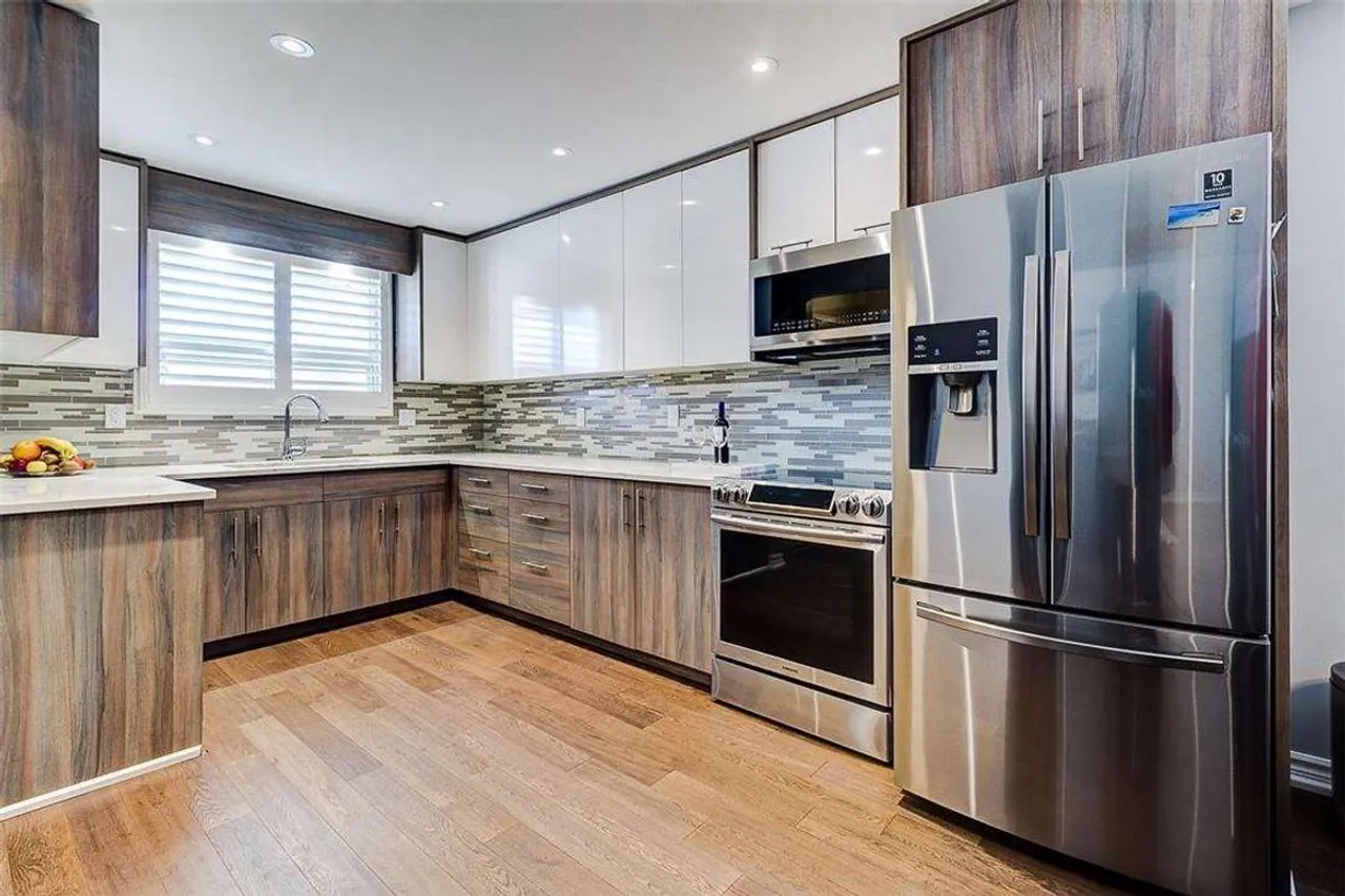 Renovated kitchen with wood-look cabinetry and stainless steel appliances