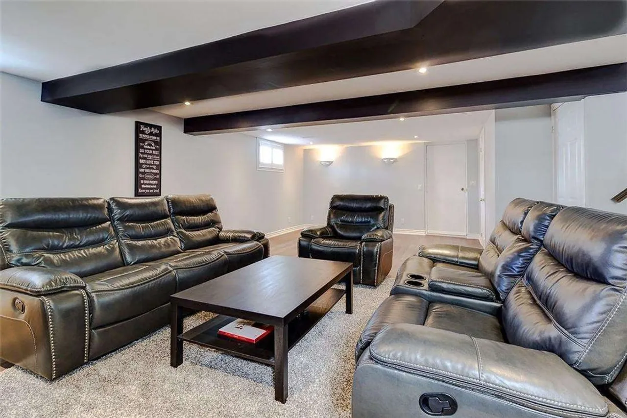 Lower-level family room with leather reclining sofas