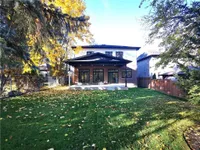Rear exterior with a covered patio, large windows, and a private backyard